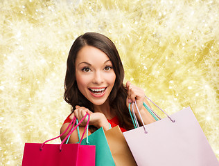 Image showing smiling woman with colorful shopping bags