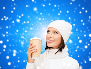 Image showing smiling young woman in winter clothes with cup