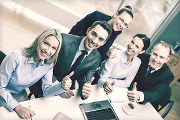 Image showing business team showing thumbs up in office