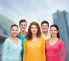 Image showing group of smiling teenagers over city background