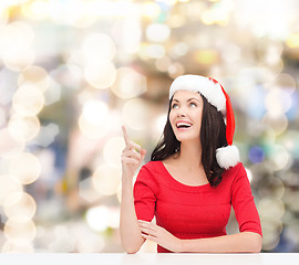 Image showing smiling woman in santa helper hat