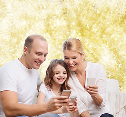 Image showing happy family with smartphones