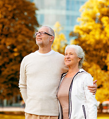 Image showing senior couple hugging in city park