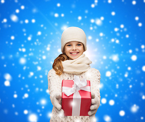 Image showing dreaming girl in winter clothes with gift box