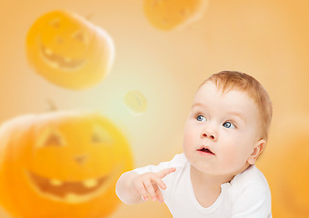 Image showing smiling baby over pumpkins background