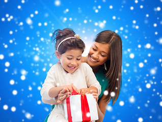 Image showing happy mother and little girl with gift box