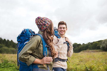 Image showing smiling couple with backpacks hiking