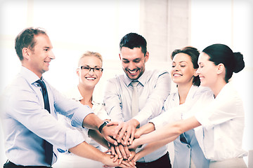 Image showing business team celebrating victory in office