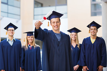 Image showing group of smiling students in mortarboards