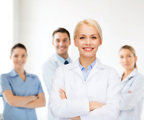 Image showing smiling female doctor with group of medics