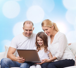 Image showing smiling family with laptop