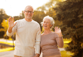 Image showing senior couple hugging in city park