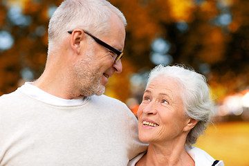 Image showing senior couple hugging in city park