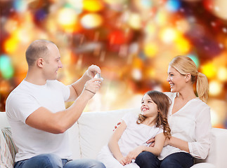 Image showing happy family with camera at home