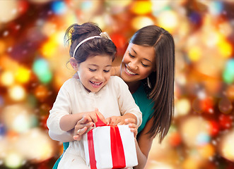 Image showing happy mother and little girl with gift box