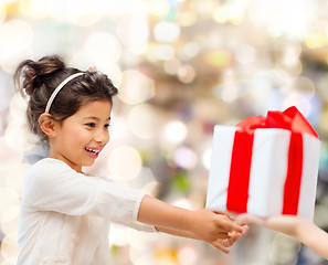 Image showing smiling little girl with gift box