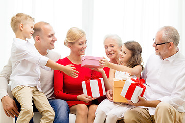 Image showing smiling family with gifts at home