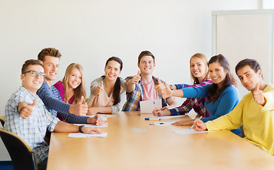 Image showing group of smiling students with hand on top