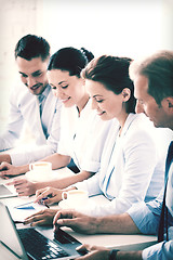 Image showing group of people working with laptops in office