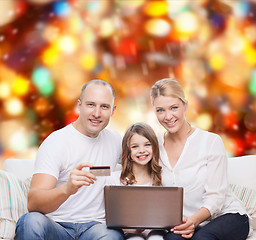 Image showing happy family with laptop computer and credit card