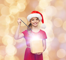 Image showing smiling girl in santa helper hat with gift box