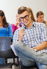 Image showing group of smiling students with notebook