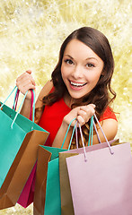 Image showing smiling woman with colorful shopping bags