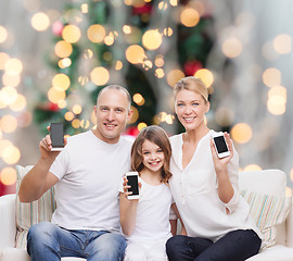 Image showing happy family with smartphones