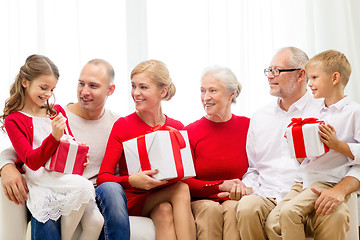 Image showing smiling family with gifts at home