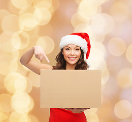 Image showing smiling woman in santa helper hat with parcel box