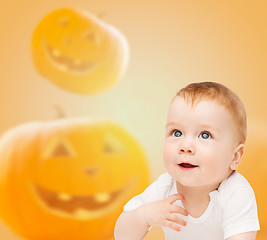 Image showing smiling baby over pumpkins background