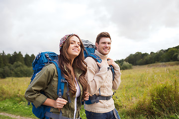 Image showing smiling couple with backpacks hiking