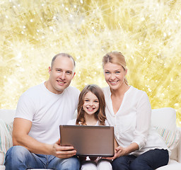 Image showing smiling family with laptop