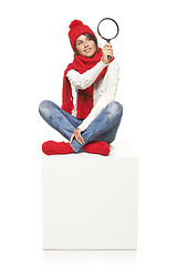 Image showing Winter woman sitting on blank billboard placard sign