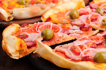 Image showing Pizza with tomato, salami, peppeeoni, olives and yellow hot pepper