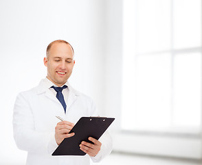 Image showing smiling male doctor with clipboard
