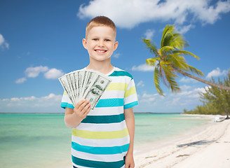 Image showing smiling boy holding dollar cash money in his hand