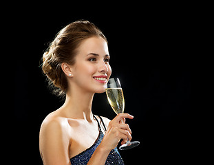 Image showing smiling woman holding glass of sparkling wine