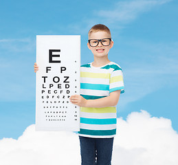 Image showing smiling boy in eyeglasses with white blank board