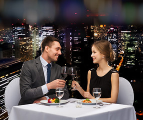 Image showing smiling couple eating main course at restaurant