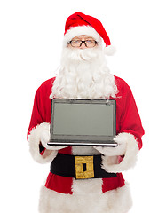 Image showing man in costume of santa claus with laptop