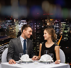 Image showing smiling couple looking at each other at restaurant