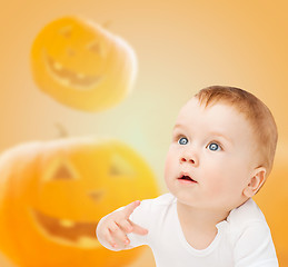 Image showing smiling baby over pumpkins background