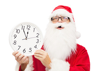 Image showing man in costume of santa claus with clock