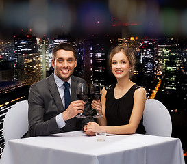 Image showing young couple with glasses of wine at restaurant