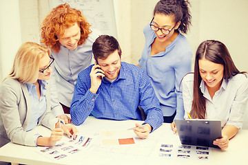 Image showing creative team with papers and clipboard at office