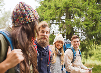 Image showing group of friends with backpacks and tablet pc