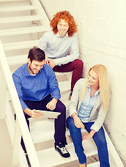 Image showing team with tablet pc computer sitting on staircase