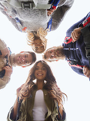 Image showing group of smiling friends with backpacks hiking