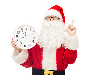 Image showing man in costume of santa claus with clock